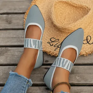 Detailed view of pointed-toe knit flat shoes with patterned elastic straps