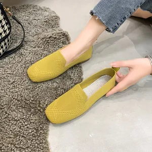 Yellow breathable fly-knit flat loafers with comfortable slip-on design for women