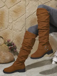 Women's brown suede slouchy mid-calf boots with buckle detail and rugged sole