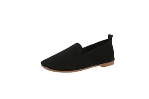 Close-up of black fly-knit flat shoes with flexible soft rubber sole for stylish women
