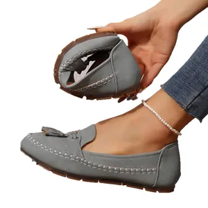 Flexible grey women's loafers with tassels and soft leather flat soles for daily wear.