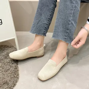Close-up of beige knitted flat loafers for women showing mesh texture and square toe fit.