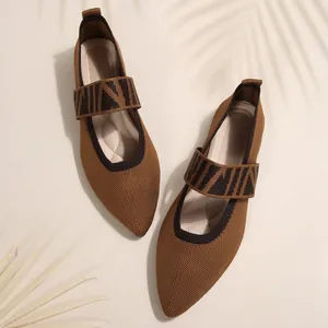 Top view detail of brown knit pointed-toe flats showing breathable mesh texture