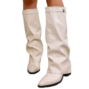 Elegant cream pant-leg pointed toe knee-high boots featuring slouchy design and metal buckle