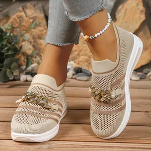 Detail of women's beige mesh slip-on sneakers with stylish gold chain ornament