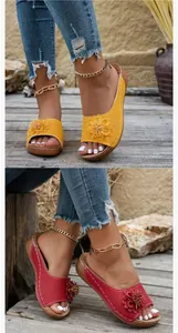 Detailed view of women's floral wedge sandals with hollow-out design and peep toe