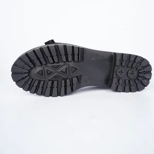 Macro detail of a black lugged sole for patent leather loafers with 37 size mark.