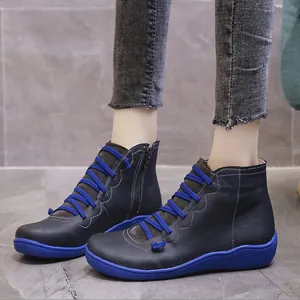 Side-view of dark blue casual ankle boots with bright blue laces and sole