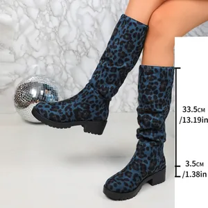 Detailed view of blue leopard print slouch boots with height and heel measurements