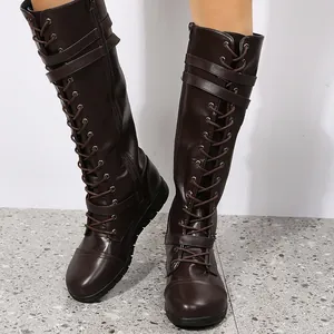 Detailed view of dark brown lace-up knee-high knight boots with buckle straps