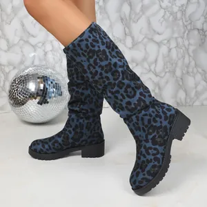 Detailed view of women's blue leopard print suede slouchy boots featuring chunky heels