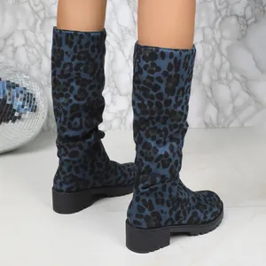 Close-up of trendy blue leopard print suede slouchy boots with chunky heels for women