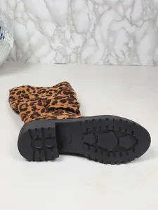 Detailed view of anti-slip rubber sole and leopard print suede fashion boot fabric