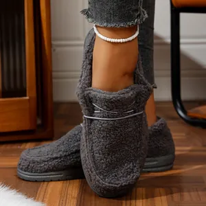 Close-up of women's gray fuzzy fleece slippers with warm lining and platform sole