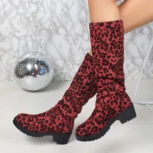 Detailed view of red leopard print suede slouch boots with thick heels and rounded toes