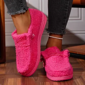 Close-up of pink plush platform loafers showing soft fleece texture and comfort