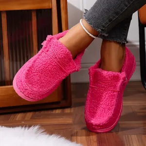Close-up of hot pink fuzzy winter loafers with thick sole and warm fleece lining.