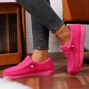 Detail view of vibrant hot pink fuzzy warm fleece loafers with thick platform soles