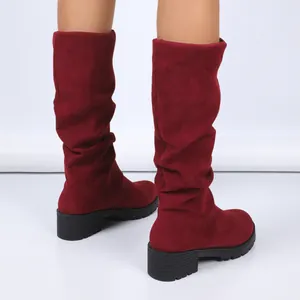 Fashionable burgundy suede slouchy boots featuring chunky heels and elegant fold design