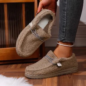 Close-up detail of women's plush brown warm loafers with fuzzy sheepskin-like texture
