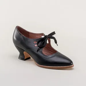 Close-up of elegant black vintage-style lace-up pumps with delicate side cutouts.