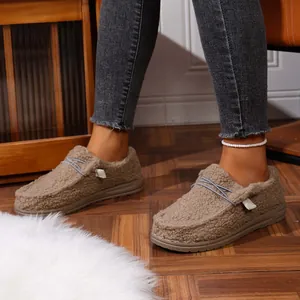 Side detail of women's warm brown sherpa fleece loafers featuring thick soles.
