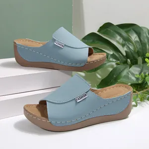 Light blue wedge-heeled slides with open toe and cushioned sole for summer beach wear