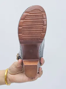 Detailed view of the anti-slip brown sole and chunky high heel of women's patent leather mule