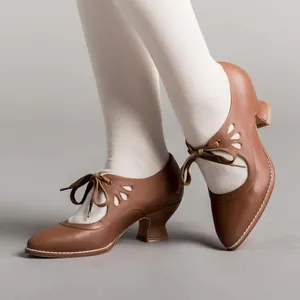 Vintage brown leather heels with delicate cut-outs and stylish ribbon laces