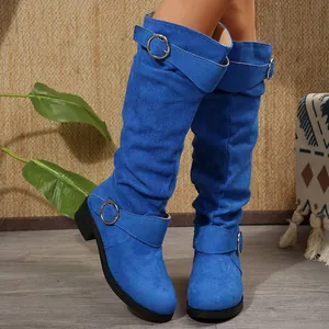 Detail view of electric blue suede knee-high boots featuring stylish silver buckle straps.
