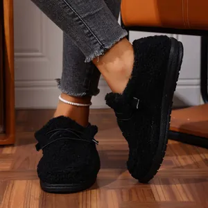 Close-up of black fuzzy winter loafers with thick platform sole for women indoor style
