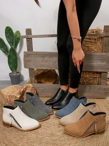 Array of stylish pointed-toe ankle boots with side zippers shown in various colors.