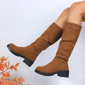 Close-up view of women's brown suede slouch boots featuring a stylish block heel and fold design