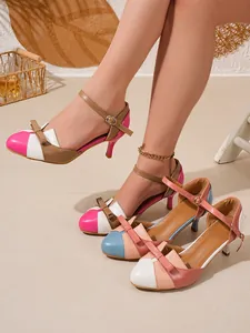Stylish color-block high-heeled sandals featuring bow detail and adjustable ankle strap