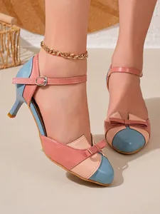 Detail of color-block kitten heel sandals with bow decoration and ankle strap