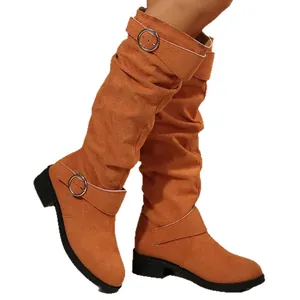 Fashionable women's slouchy tan suede knee-high boots featuring elegant buckle straps