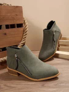 Chic olive green ankle boots featuring dual side zippers and a low block heel detail.