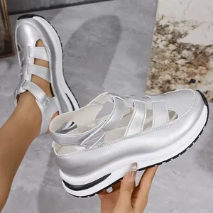 Close-up view of silver metallic platform sandals with breathable hollow closed-toe design