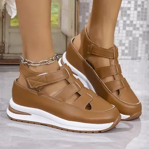 Detailed shot of brown hollow-out platform sandals with velcro straps for women