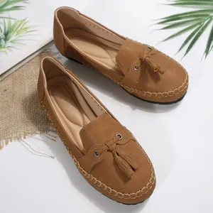 Detailed view of brown ladies' tassel loafers with contrast stitching and soft insole