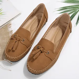 Stylish brown faux suede loafers for women featuring tassel detail and a flat slip-on design