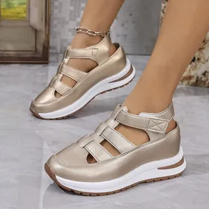 Close-up of champagne gold wedge sandals with hollow design and platform sole