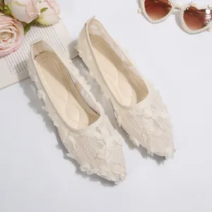Cream lace pointed toe flats with 3D floral appliqués for a romantic summer look.
