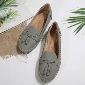 Detailed top view of grey women's loafers featuring tassels and contrast stitching