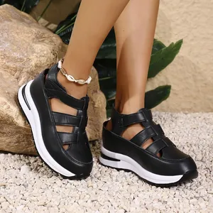 Detail of black hollow platform wedge sandals with magic sticker closure for women