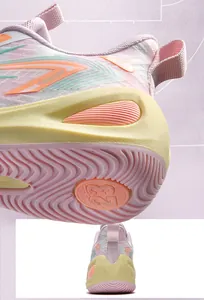 Macro view of pink and yellow basketball shoe sole with traction pattern and heel