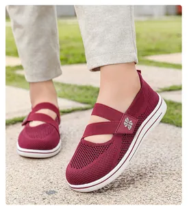 Detail of breathable burgundy mesh walking shoes for women in an outdoor setting
