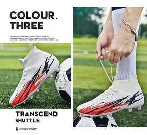 Close-up of white high-top soccer cleats being tied on an artificial grass football pitch