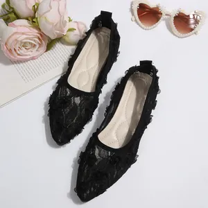 Detailed view of black floral lace mesh flat shoes with pointed toe