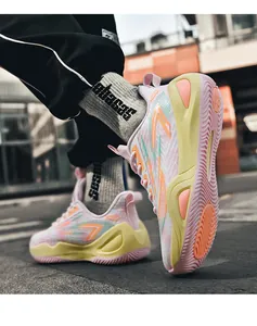 Side detail view of colorful breathable mesh basketball shoe with a textured pink sole